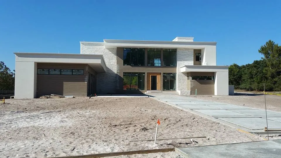 Front elevation flat roof modern home sandy lot new driveway, Lake Mary